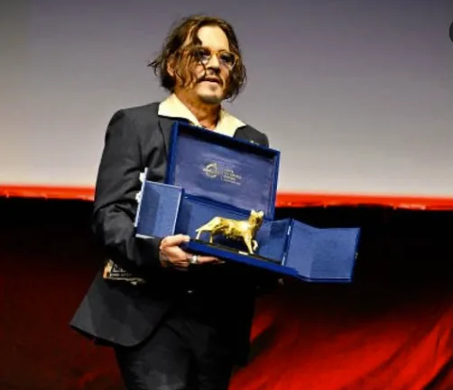 Johnny Depp holding the prestigious Lifetime Achievement Award at the Rome Film Festival